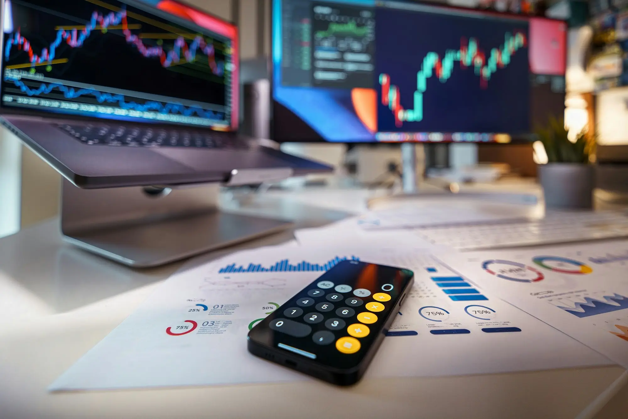 Cash flow forecast charts on screens beside a calculator